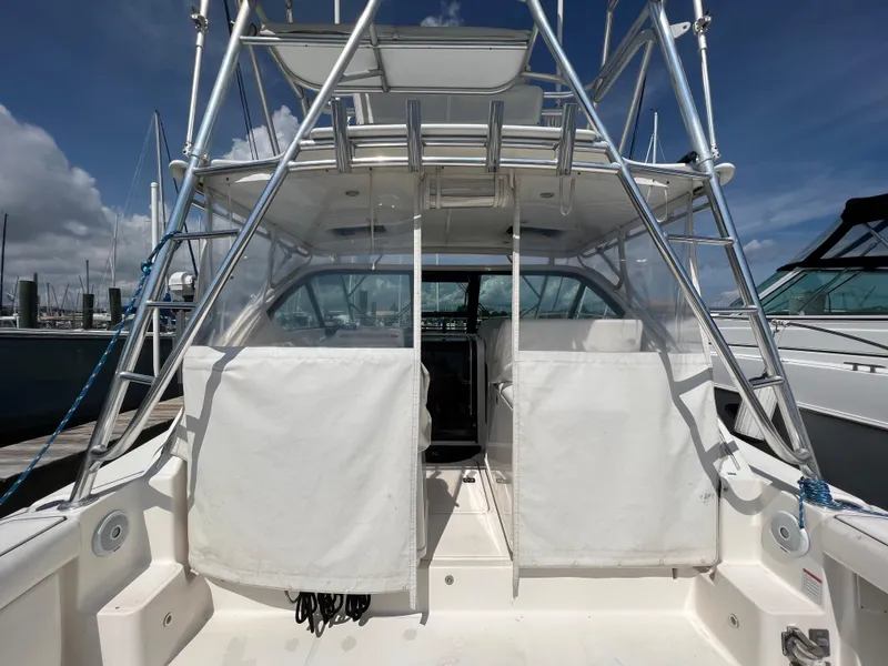 Slide: The Image of 2004 Tiara Yachts 3200 Open boat docked at marina, rear view. - 5