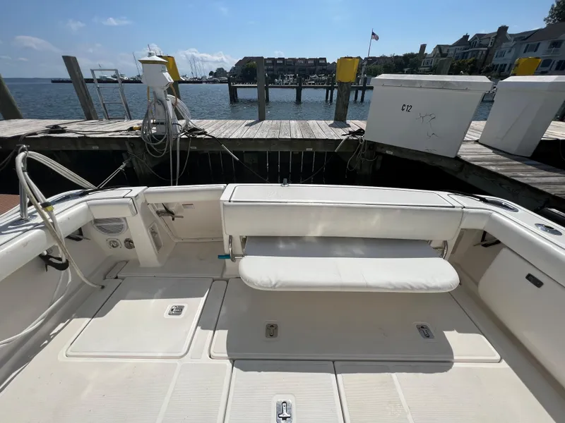 Slide: The Image of 2004 Tiara Yachts 3200 Open at dock, showcasing spacious deck and seating area. - 7