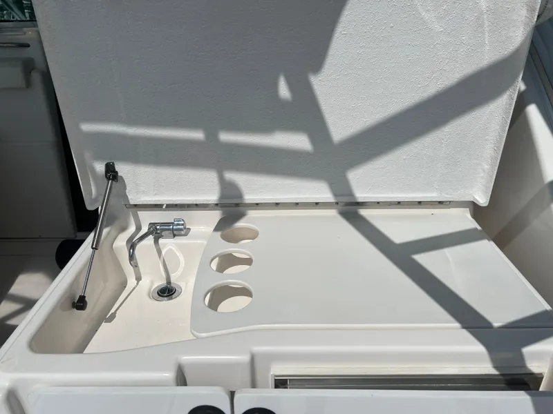 Slide: The Image of 2004 Tiara Yachts 3200 Open sink and countertop area in sunlight. - 9