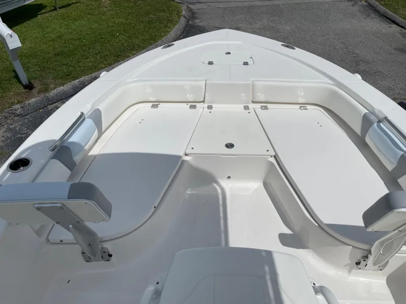 Slide: The Image of 2024 Robalo 206 Cayman boat bow seating area with white cushions. - 10