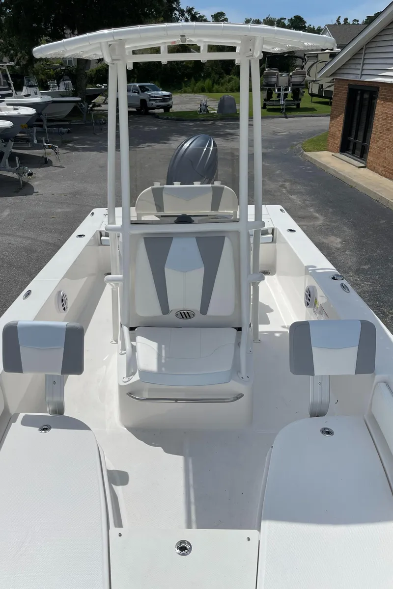 Slide: The Image of 2024 Robalo 206 Cayman center console boat with white and gray seating. - 13