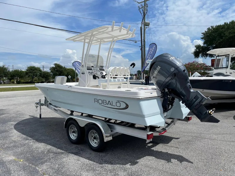 Slide: The Image of 2024 Robalo 206 Cayman boat on a trailer, featuring a powerful outboard motor. - 3