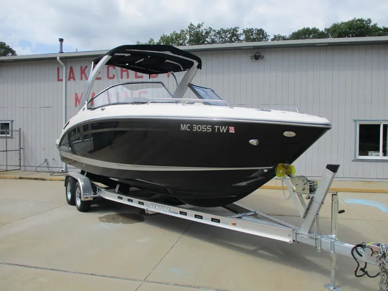 The Image of 2015 Chaparral 257 SSX boat on trailer in front of building. - 0