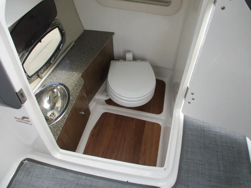 Slide: The Image of Interior of 2015 Chaparral 257 SSX with toilet and sink. - 10