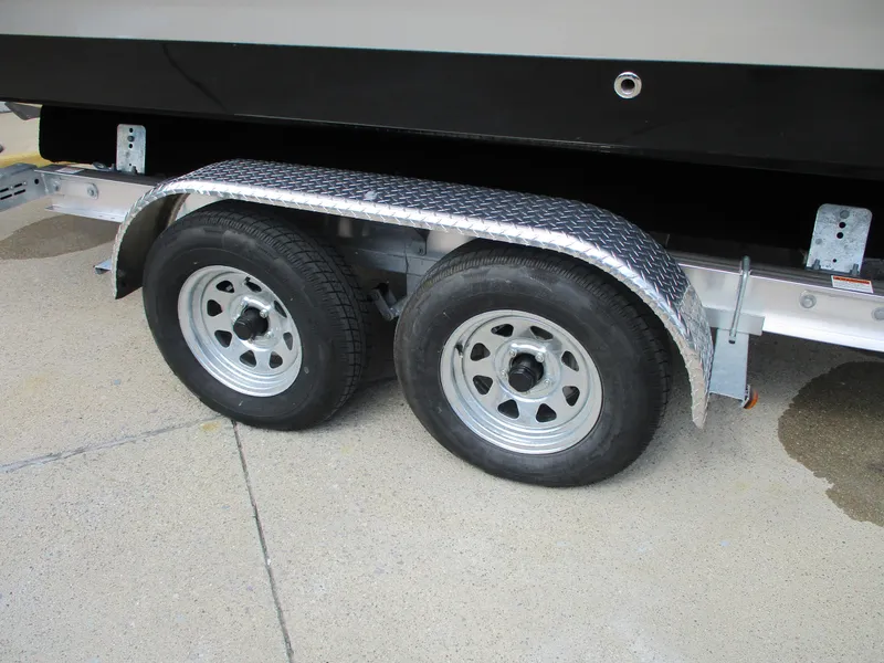 Slide: The Image of Dual trailer wheels of a 2015 Chaparral 257 SSX boat trailer. - 16