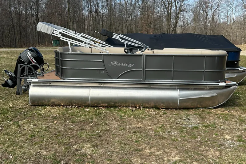 The Image of 2024 Bentley Pontoons LE 180 CR pontoon boat on grass with forest background. - 0