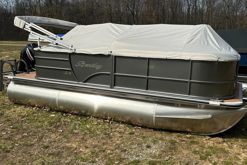 Slide: The Image of 2024 Bentley Pontoons LE 180 CR pontoon boat with cover in outdoor setting. - 12