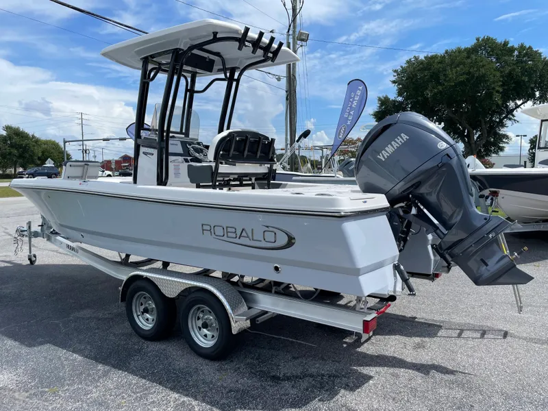 Slide: The Image of 2024 Robalo 226 Cayman boat on a trailer with Yamaha outboard motor. - 0