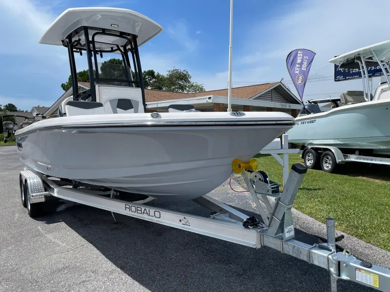 Slide: The Image of 2024 Robalo 226 Cayman boat on a trailer, displayed outdoors. - 1