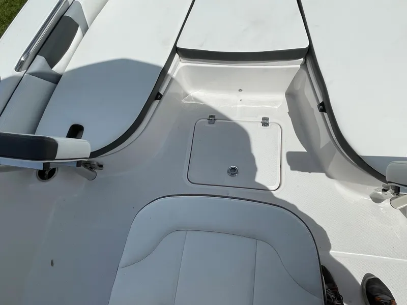 Slide: The Image of 2024 Robalo 226 Cayman boat interior seating and storage area. - 10
