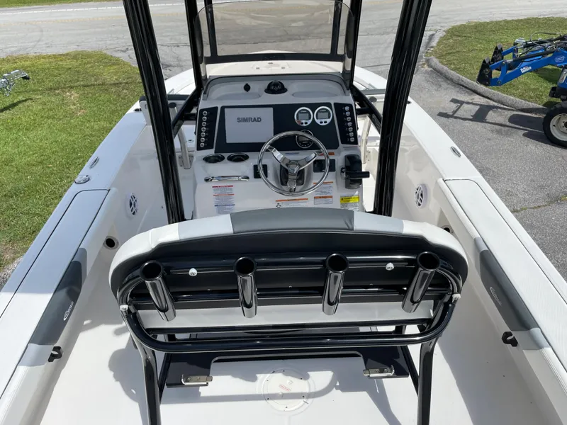 Slide: The Image of 2024 Robalo 226 Cayman boat interior with steering console and rod holders. - 15