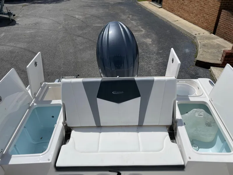 Slide: The Image of 2024 Robalo 226 Cayman boat stern view with storage compartments and outboard motor. - 18