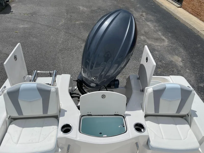 Slide: The Image of 2024 Robalo 206 Cayman boat with dual seating and outboard motor. - 7
