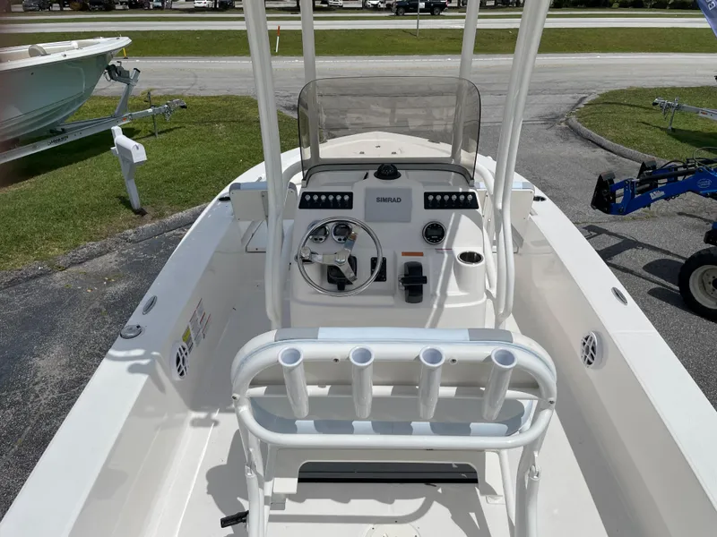 Slide: The Image of 2024 Robalo 206 Cayman center console boat with rod holders and steering wheel. - 8