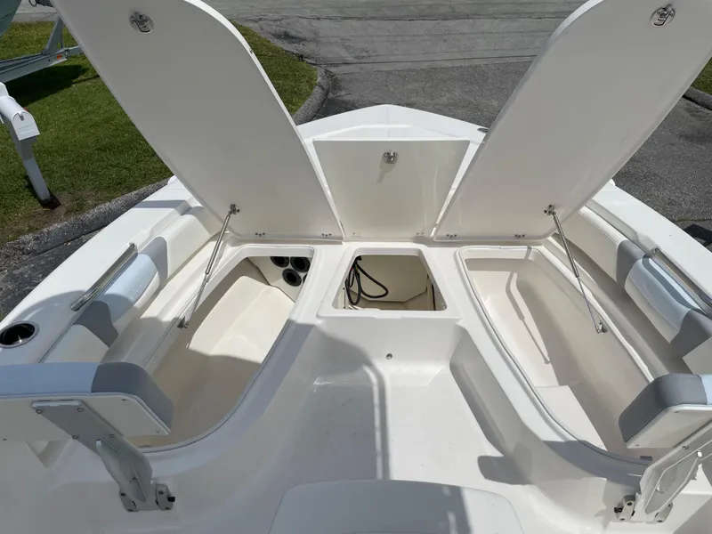 Slide: The Image of 2024 Robalo 206 Cayman boat with open storage compartments. - 11