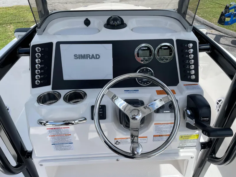 Slide: The Image of 2024 Robalo 226 Cayman boat console with Simrad display and steering wheel. - 14
