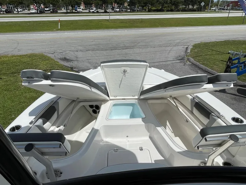 Slide: The Image of 2024 Robalo 226 Cayman boat interior with open storage compartments and seating. - 8