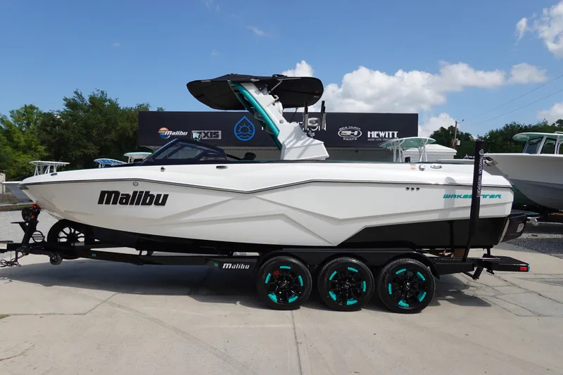 The Image of 2023 Malibu 25 LSV boat on a trailer, side view. - 0