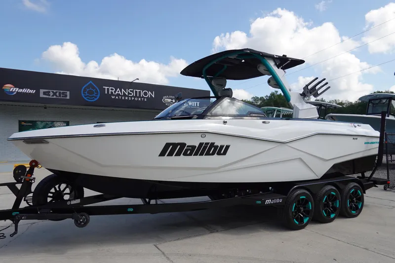 Slide: The Image of 2023 Malibu 25 LSV boat on trailer at Transition Watersports dealership. - 1