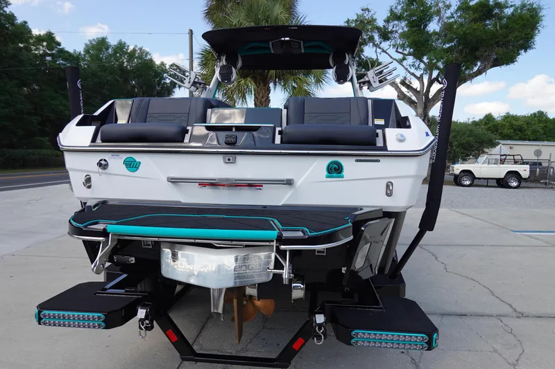Slide: The Image of 2023 Malibu 25 LSV boat rear view with swim platform and seating. - 10