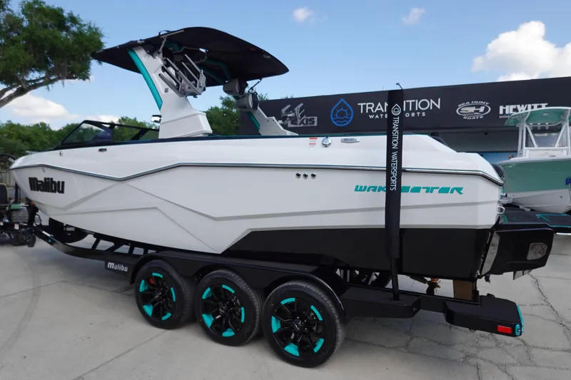 Slide: The Image of 2023 Malibu 25 LSV boat on trailer at Tradition Water Sports dealership. - 12