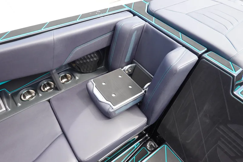 Slide: The Image of 2023 Malibu 25 LSV boat interior with luxurious seating and cup holders. - 29