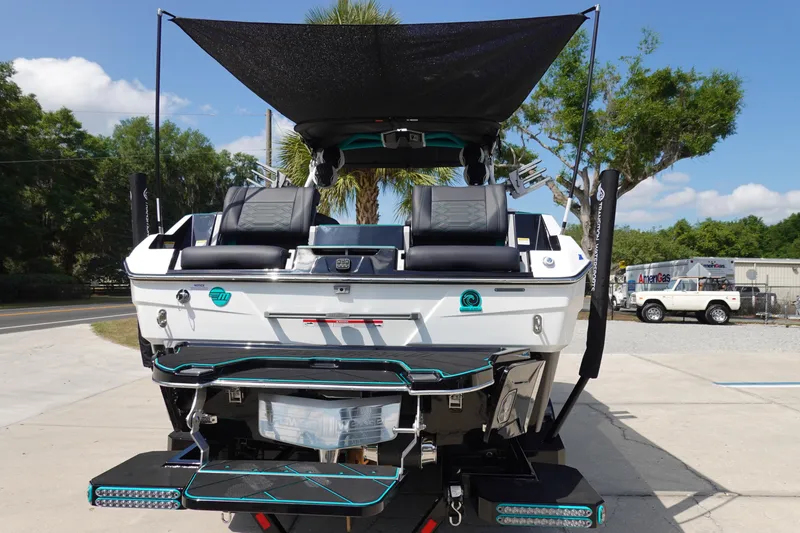 Slide: The Image of 2023 Malibu 25 LSV boat rear view with canopy and seating. - 42