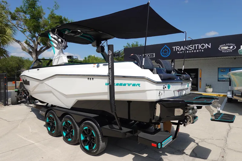 Slide: The Image of 2023 Malibu 25 LSV boat on trailer at Transition Watersports dealership. - 43