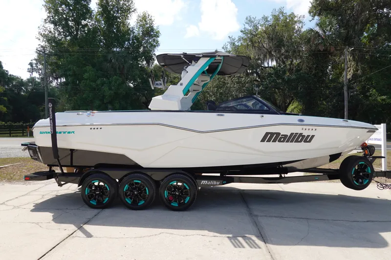 Slide: The Image of 2023 Malibu 25 LSV boat on a trailer, side view. - 5