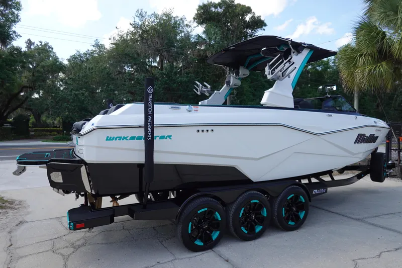 Slide: The Image of 2023 Malibu 25 LSV Wakesetter boat on a trailer, side view. - 6
