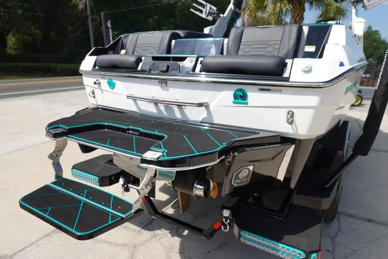 Slide: The Image of 2023 Malibu 25 LSV boat rear view with swim platform and seating. - 7