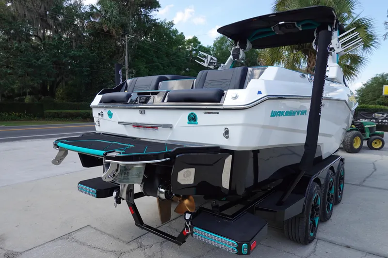 Slide: The Image of 2023 Malibu 25 LSV boat on trailer, rear view, parked outdoors. - 8