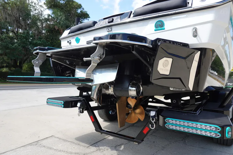 Slide: The Image of 2023 Malibu 25 LSV boat rear view showcasing propeller and swim platform. - 9