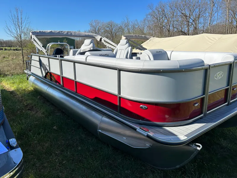 The Image of 2024 Bentley Pontoons Legacy Swingback 220 pontoon boat with red and gray exterior. - 0