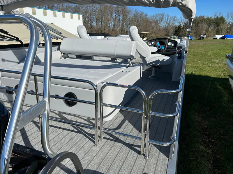 Slide: The Image of 2024 Bentley Pontoons Legacy Swingback 220 interior with seating and steering console. - 14