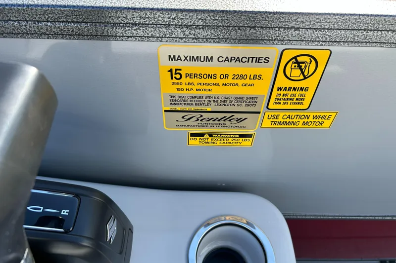 Slide: The Image of 2024 Bentley Pontoons Legacy Swingback 220 capacity label, 15 persons or 2280 lbs, warning signs. - 18
