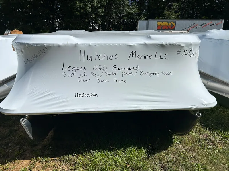 Slide: The Image of 2024 Bentley Pontoons Legacy Swingback 220 wrapped and labeled at Hutches Marine LLC. - 19