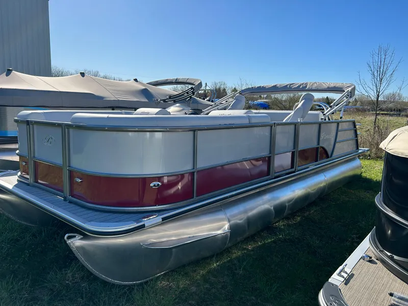 Slide: The Image of 2024 Bentley Pontoons Legacy Swingback 220 pontoon boat in a lot. - 2