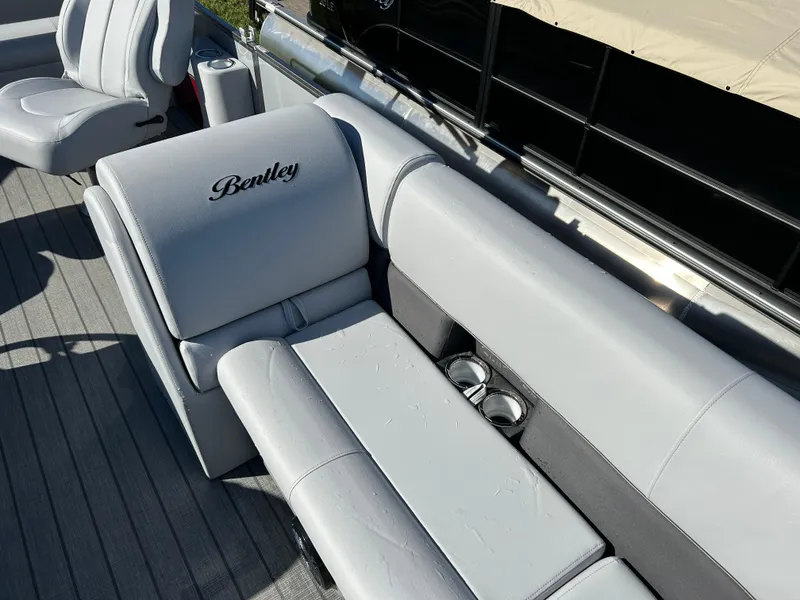 Slide: The Image of 2024 Bentley Pontoons Legacy Swingback 220 interior seating and cup holders. - 5