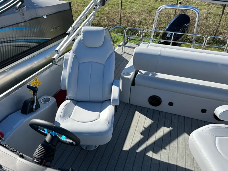 Slide: The Image of 2024 Bentley Pontoons Legacy Swingback 220 interior with captain's chair and seating area. - 7