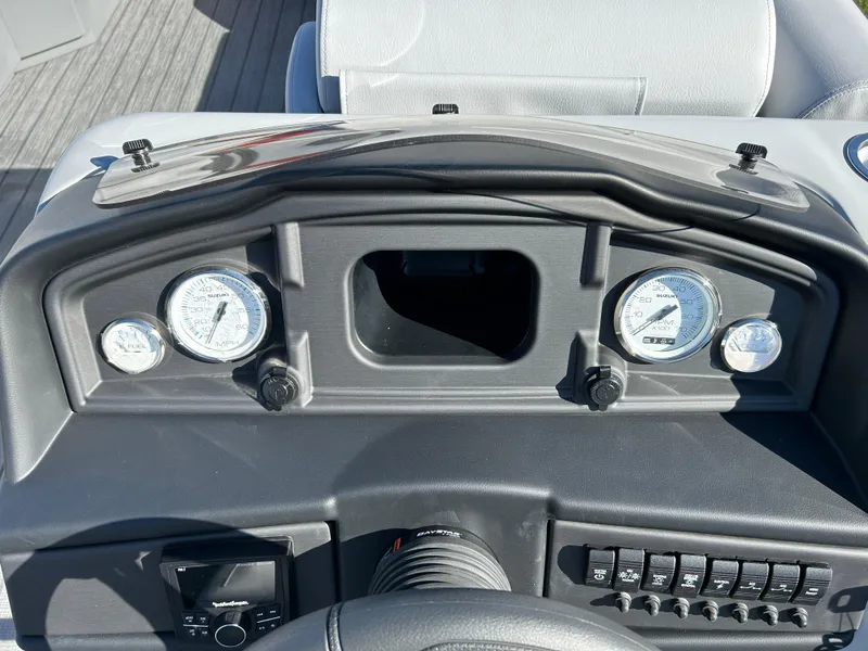 Slide: The Image of 2024 Bentley Pontoons Legacy Swingback 220 dashboard with gauges and controls. - 8