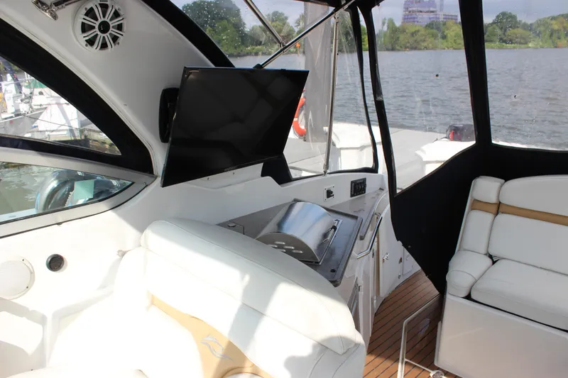 Slide: The Image of Interior of 2011 Rinker 310 Express Cruiser with TV and seating area. - 16