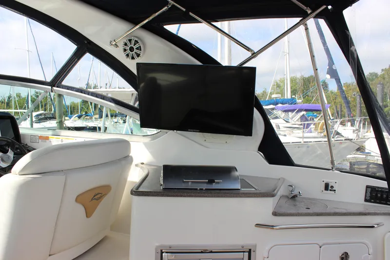 Slide: The Image of 2011 Rinker 310 Express Cruiser interior with TV and seating. - 19