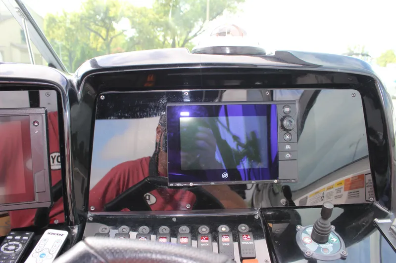Slide: The Image of Control panel of a 2011 Rinker 310 Express Cruiser with navigation screen. - 25