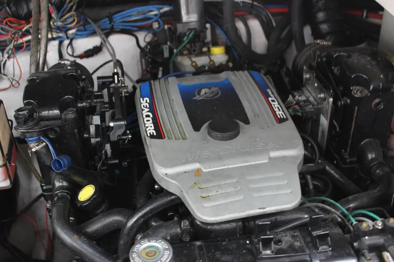 Slide: The Image of 2011 Rinker 310 Express Cruiser engine compartment with MerCruiser SeaCore engine. - 36