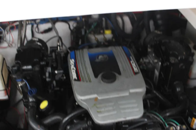 Slide: The Image of 2011 Rinker 310 Express Cruiser engine compartment with MerCruiser engine. - 37