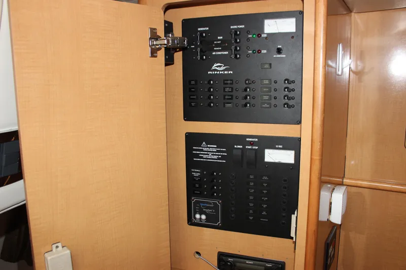 Slide: The Image of Electrical control panel on a 2011 Rinker 310 Express Cruiser boat. - 44
