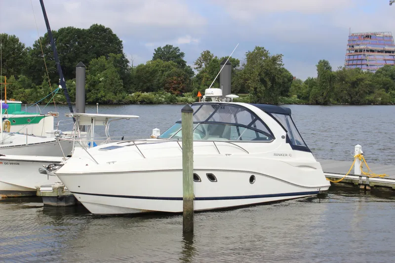 Slide: The Image of 2011 Rinker 310 Express Cruiser docked at a marina. - 6