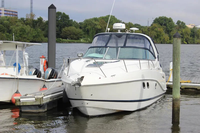 Slide: The Image of 2011 Rinker 310 Express Cruiser docked at a marina. - 7