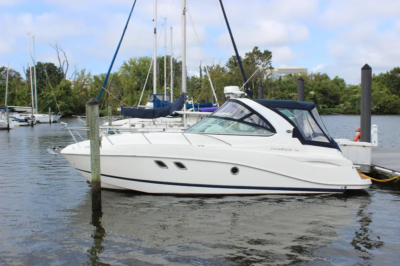 Slide: The Image of 2011 Rinker 310 Express Cruiser docked at a marina. - 9